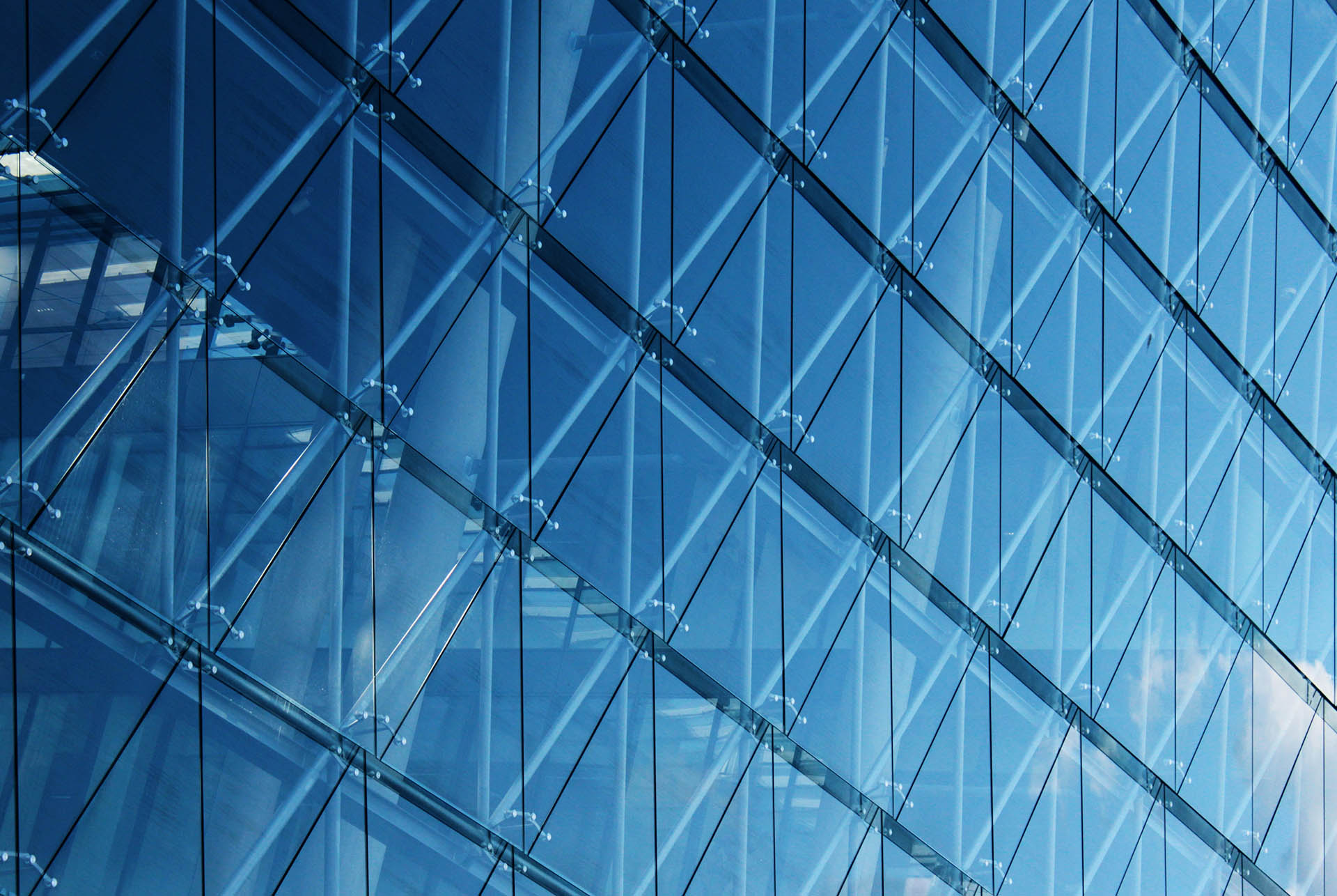The side of a building with large glass panels that represent Q Lifestyle company